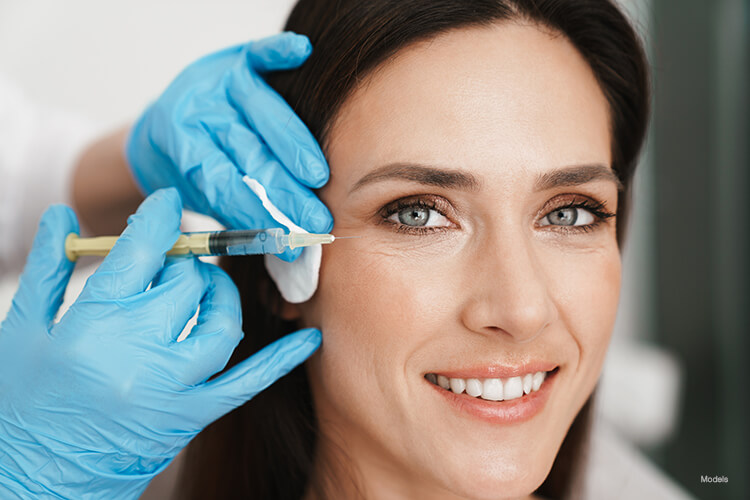 A woman getting an injection on her crows feet