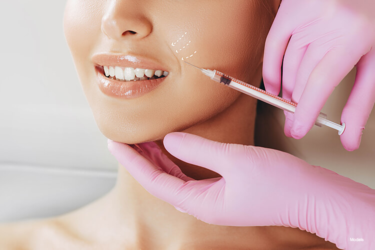 A woman getting an injection on her face