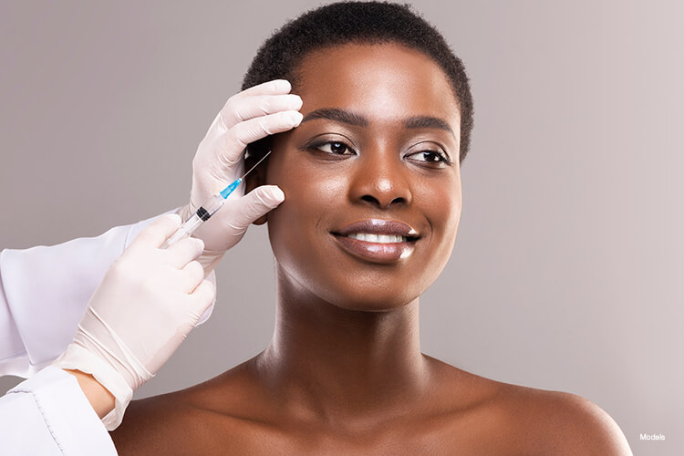 A woman getting an injection on her upper face