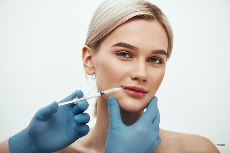 Young woman getting a lip injection